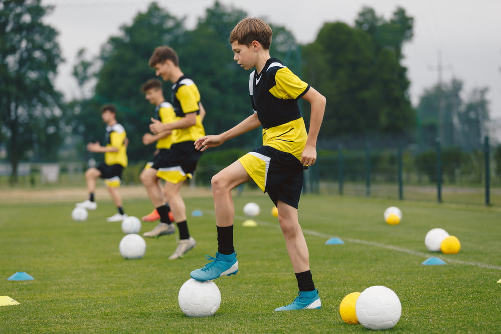 Teenage,Boys,Training,Sports,In,A,Row.,Soccer,Summer,Camp